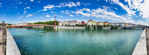 Panoramic view on the red bridge Passerelle du Palais de Justice of Lyon and river embankment, travel and tourism concept