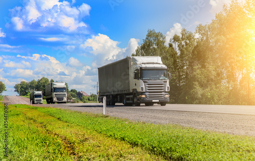 Truck convoy delivers goods on a country road