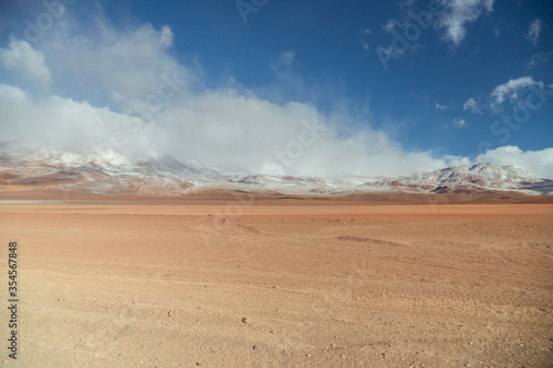 Landscape mountain Water Lake. Dry, Barren desert, snowcapped mountains wilderness. Mountain range view. Salt Flats, Uyuni, Bolivia. Copy space, Rocks, blue sky, nature, hiker, hiking