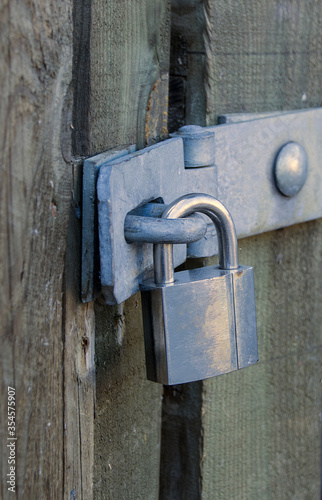 Padlock on a wooden gate