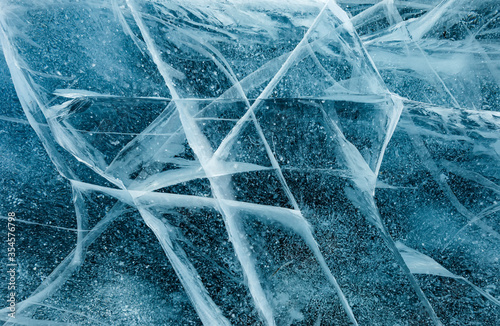 Abstract cracks of frozen Baikal lake of blue color