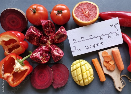 Foods rich in lycopene with structural chemical formula of lycopene molecule. Natural sources of lycopene: tomato, grapefruit, pomegranate, red bell pepper, beetroot, mango and carrot.