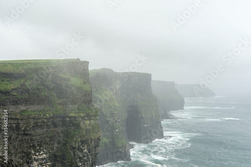 cliff of moher in ireland on rainy and foggy day