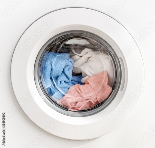 Working washing machine on white background