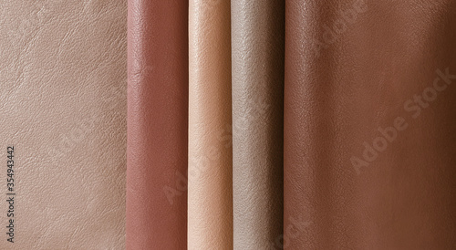 Artificial leather in variety shades of brown colors in classic mood. abstract brown leather sample catalog background.