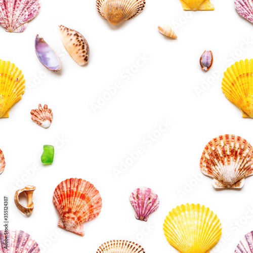 Seamless photo pattern with different sea shells. Flat lay with colorful mollusc shells, corals and wave-worn pieces of glass and stones. Top view on finds from ocean beach. Circle copy space.