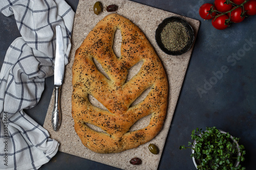 Fugasse bread with sesame seeds and herbs