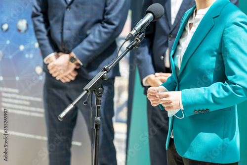 Business woman or female politician is giving a speech at media event