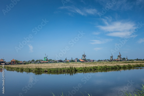 Dutch windmills in a blue sky summer day in the Netherlands polder