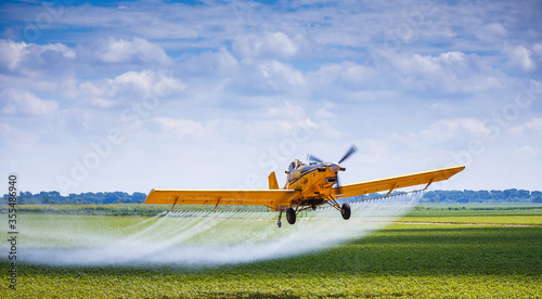 Yellow Crop Duster Airplane Aerially Applies Pesticide to Cotton Fields in Texas