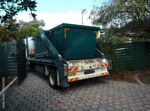 Skip hired being delivered on a truck