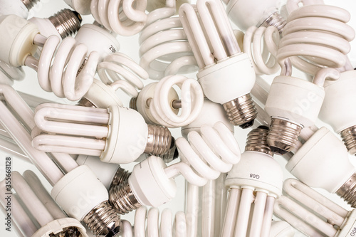 Spiral Energy saving fluorescent electric light bulbs. Old burnt lamps