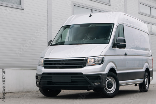 Modern cargo van near warehouse