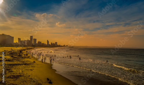 Durban golden mile beach with white sand and skyline South Africa during sunset and golden hour
