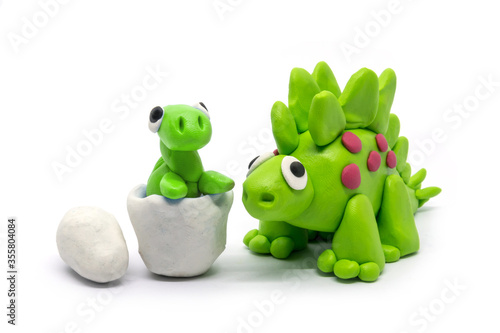 Play dough Stegosaurus and egg on white . Handmade clay plasticine