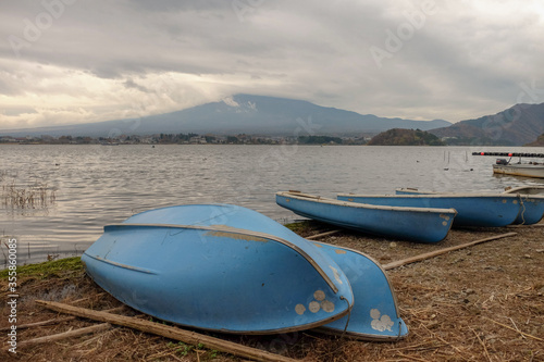The empty rowing boats park on the shore of lake Kawaguchiko, Japan. 