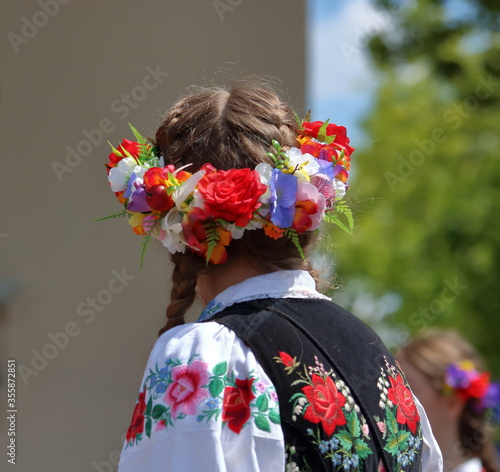 Attractive young girl in traditional folk costume and wearth from Lowicz region, Poland