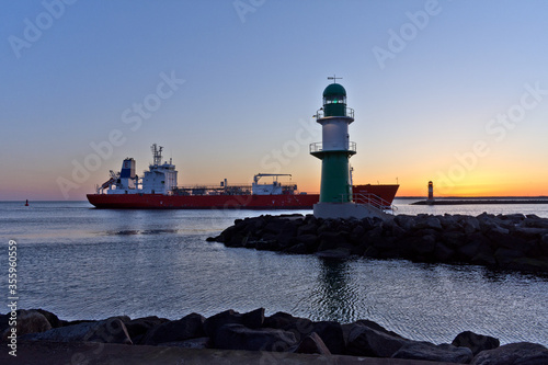 Ship With Lighthouse at Warnemünde Port While Sunrise, Rostock, Baltic Sea, Mecklenburg Western Pomerania, Germany, Europe