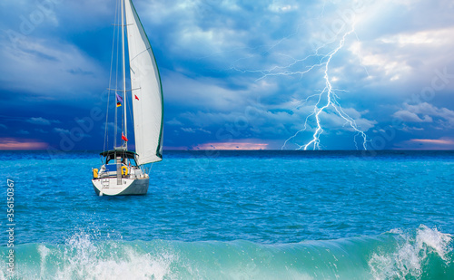 Sailing yacht in a stormy weather with lightning