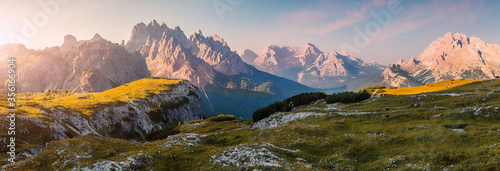 Wonderful Alpine highlands during sunrise. Morning panoramic view of Dololites mountains, Italian Dolomites Alps under sunlight. Awesome landscape with colorful sky over the Cadini di Misurina range.