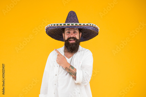 mexican day of the dead. national mexico holiday. mexican hat sombrero and mustache. Enjoying summer. man in festive mood pointing finger. 5th of may. brutal bearded man in mexican sombrero hat