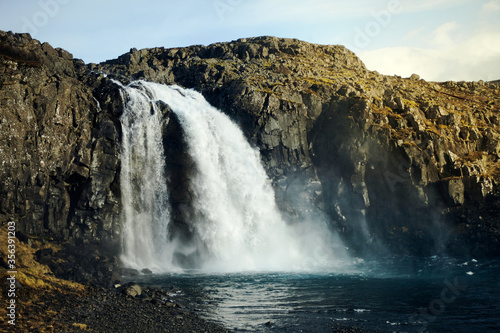 Wild waterfall in Iceland. Waterfall in the light of the setting sun, wild nature. nobody around.
