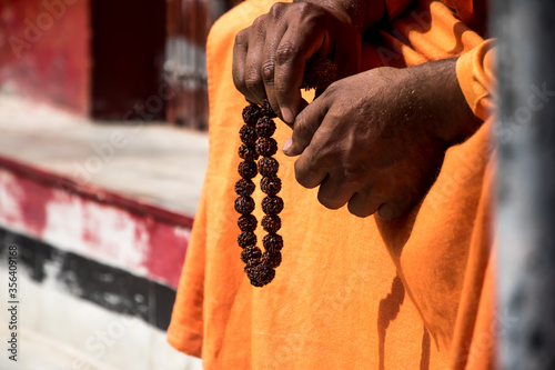 Image of an Indian sadhu sitting in a meditation pose with rudraksha