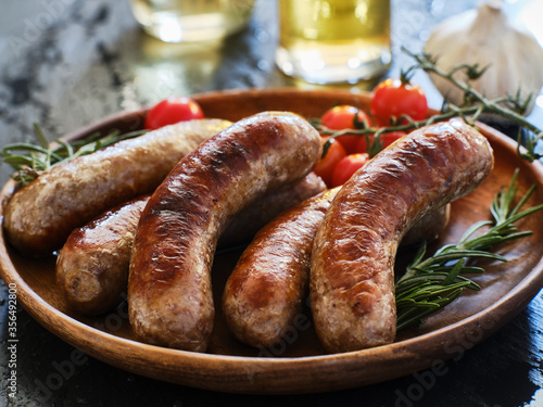 plate of german bratwurst sausages with herbs