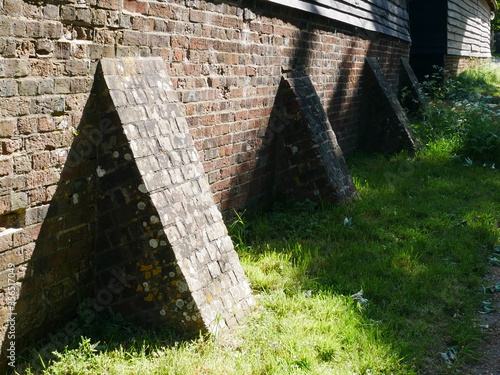 Row of brick buttresses holding up a wall