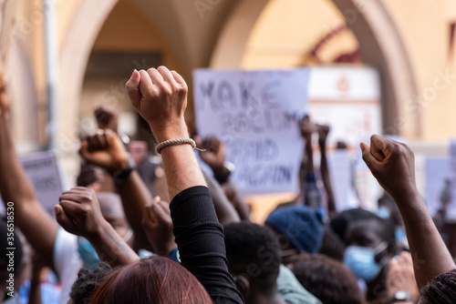 People raising fist with unfocused background in a pacifist protest against racism demanding justice