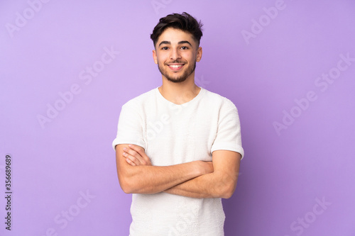 Arabian handsome man over isolated background keeping the arms crossed in frontal position