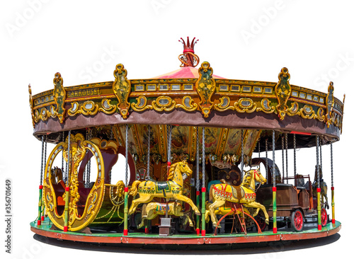 Old fashioned merry-go-round fairground attraction with horses, cart and a slay. Isolated on a white background