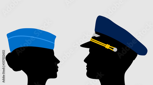 Pilot and stewardess in uniform caps