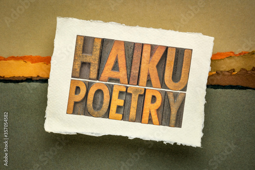 haiku poetry - a very short form of Japanese poetry - isolated word abstract in vintage letterpress wood type in a sketchbook against abstract landscape