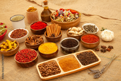Various spices and herbs as a background.