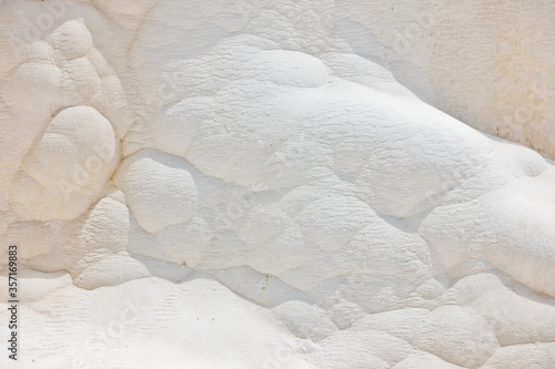 Details of white carbonate mineral rocks made by water flow at Pamukkale near archelological site Hierapolis, Denizli, Turkey