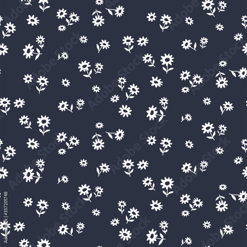 Seamless pattern of small flowers on black. Floral vector background