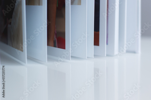 Pages of a photo album reflected on a table