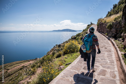 backpacker hiking trail by a huge beautiful lake