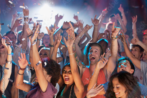 Enthusiastic crowd cheering at concert