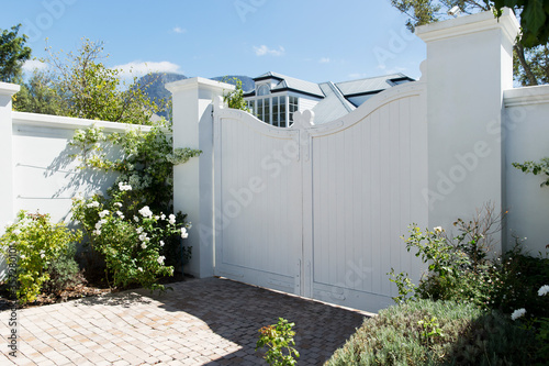 White gate outside luxury house