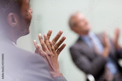 Businessmen clapping in meeting