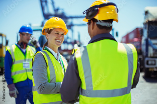 Business people wearing protective workwear talking