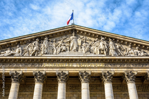 Low angle view of the pediment of the Palais Bourbon, seat of the french National Assembly in Paris, France, bearing the inscription Assemblée Nationale in golden letters.