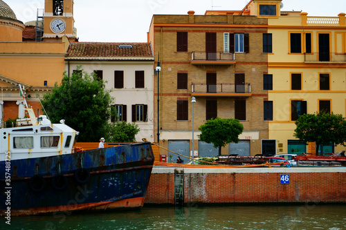 Old fishing boat in port with low sea level