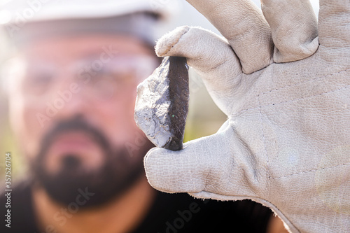 rough ore stone, palladium nugget. Concept of metal mining used in the industry. Spot focus