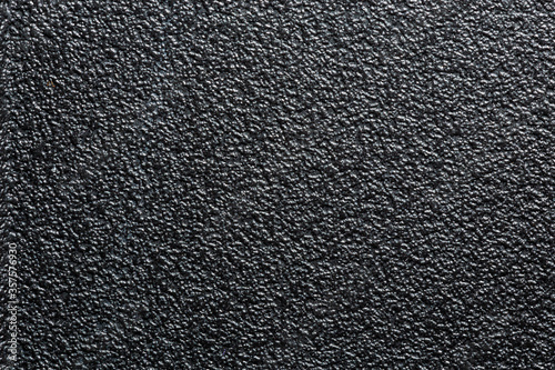 flat black rugged plastic or rubber surface with decorative bumpy finish