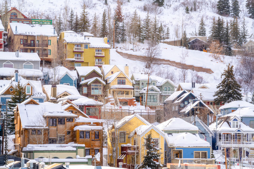 Beautiful homes sitting on snow covered hill in Park City Utah viewed in winter