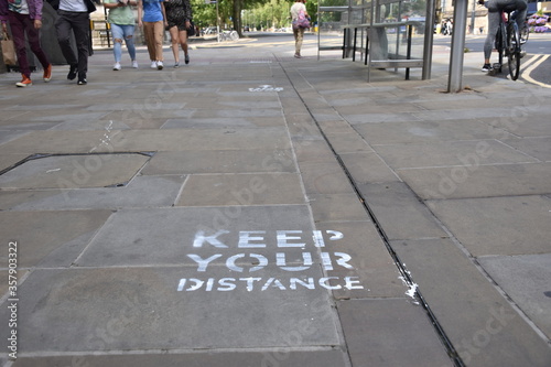 Oxford, UK- 06 13 2020: Oxford introduces social distancing to the city centre streets. A keep your distance sign on the pavement is one of the measures.