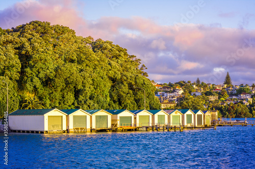 Setting sun highlights a row of boat sheds in central Auckland,